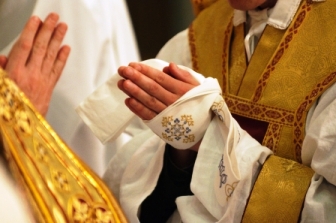 The manutergium (from the Latin manu+tergium = hand towel) is a long cloth that was used in the preconciliar rite of ordination. It was wrapped around the hands of the newly ordained priest after the Bishop anointed his hands with the sacred Chrism. The purpose was to prevent excess oil from dripping onto vestments or the floor during the remainder of the ordination rites.