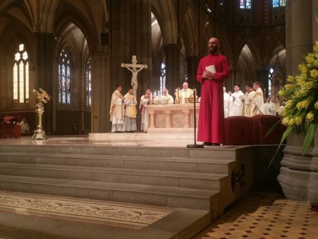 The new priests join the archbishop at the altar