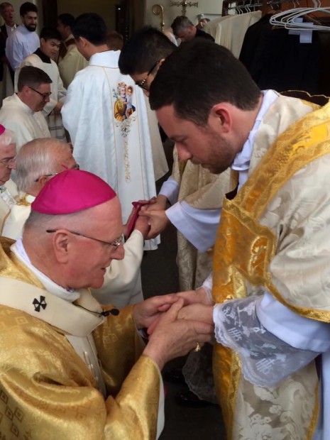 Archbishop Hart venerates Fr Joel's newly anointed hands
