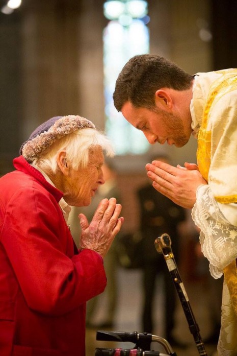 Fr Joel prays with someone seeking his priestly blessing