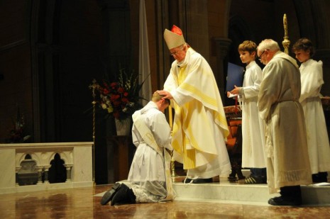 Bishop Peter Connors lays hands